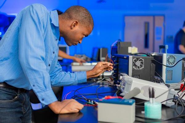 A student researcher adjusts equipment used in lightning research